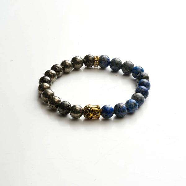 Flat lay of pyrite and lapis lazuli beads with gold Buddha charm on white background