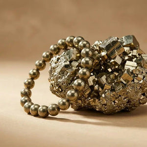 Pyrite Peru bracelet beside a raw pyrite cluster for wealth and abundance - Soultheory India
