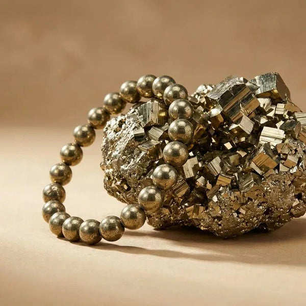 Pyrite Peru bracelet beside a raw pyrite cluster for wealth and abundance - Soultheory India