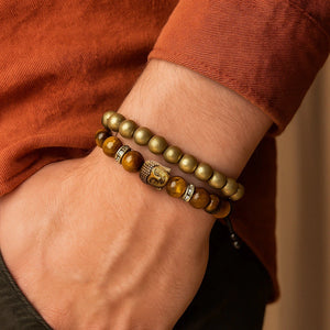 Man wearing pyrite and tiger eye Buddha bracelet stack on wrist for confidence