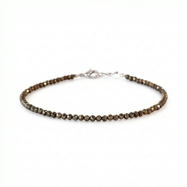Raw pyrite faceted bead anklet with silver clasp on white background