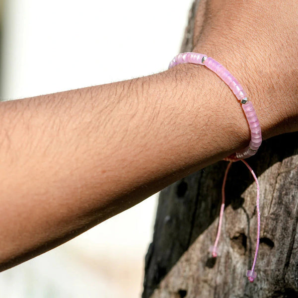 Rose quartz love and harmony bracelet with adjustable pink cord worn on wrist