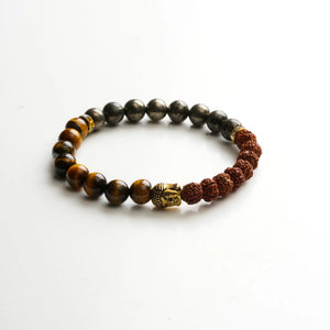 Rudraksha, pyrite and tiger eye bracelet on white showing gold Buddha bead and beaded strand design