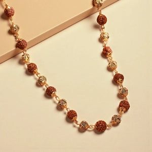 Rudraksha vel mala laid flat showing alternating rudraksha and gold plated beads