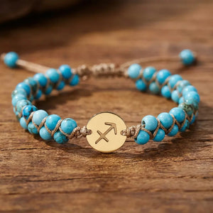 Close-up of turquoise beads and gold Sagittarius archer charm on the woven zodiac energy bracelet