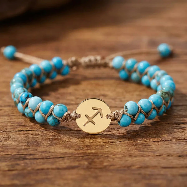 Close-up of turquoise beads and gold Sagittarius archer charm on the woven zodiac energy bracelet