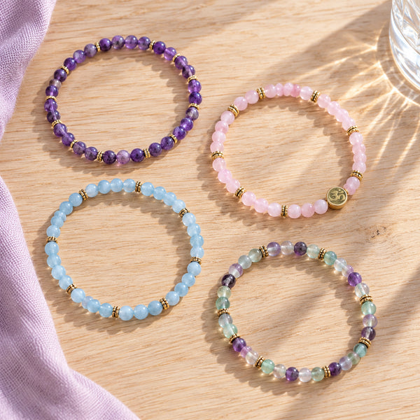 Soultheory Soothe 4 mm bracelet stack with Amethyst, Rose Quartz - four bracelets on a sunlit table