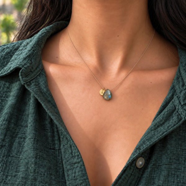 Model wearing Labradorite necklace and hanging A initial on subtle cord