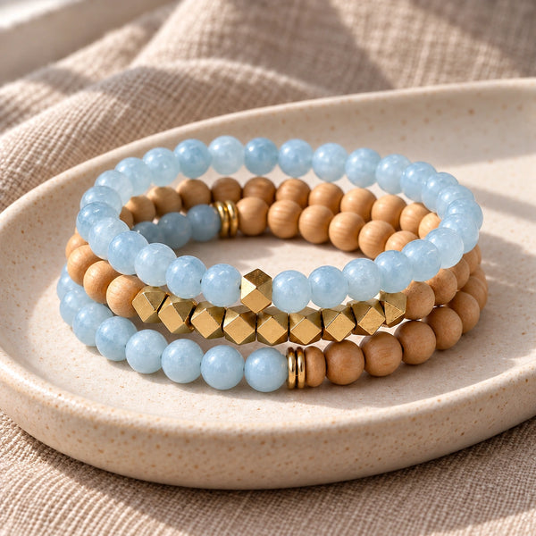 Three Aquamarine and Rosewood bead bracelets stacked on an ivory tray