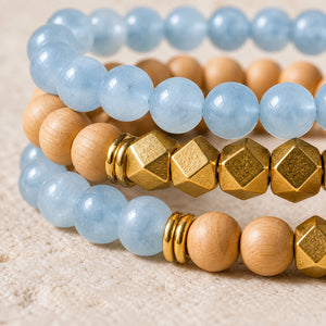 Macro close-up of Aquamarine beads, rosewood and gold-tone accents