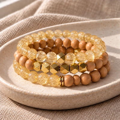 Three Citrine and Rosewood bead bracelets stacked on an ivory tray