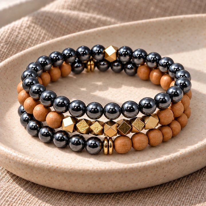 Three Hematite and Rosewood bead bracelets stacked on an ivory tray