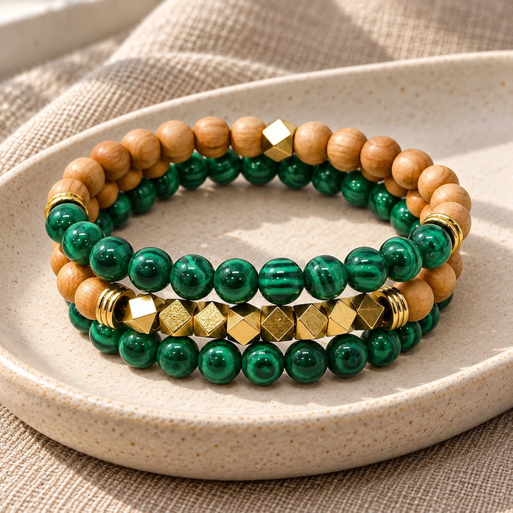 Three Malachite and Rosewood bead bracelets stacked on an ivory tray
