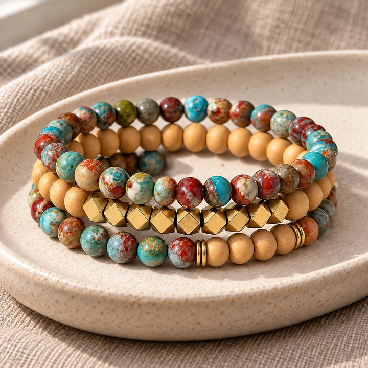 Three Multi Imperial Jasper and Rosewood bead bracelets stacked on an ivory tray