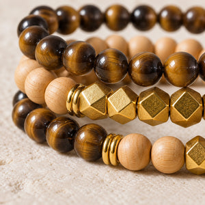 Macro close-up of Tiger Eye beads, rosewood and gold-tone accents