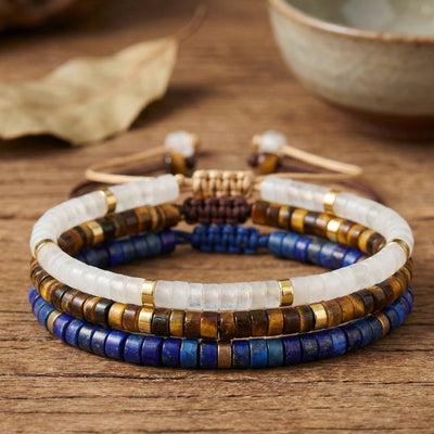 Clear quartz, tiger eye and lapis lazuli exam success bracelet set stacked on wood - Soultheory India