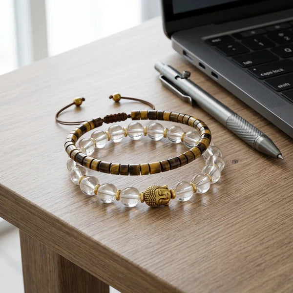 Tiger eye and clear quartz combo resting on an office desk beside a laptop for daily productivity