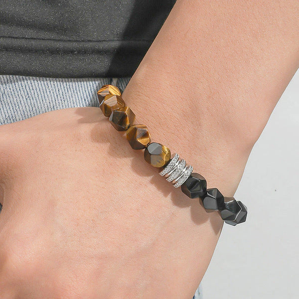 Tiger eye and obsidian bracelet worn on wrist showing faceted brown and black beads with silver spacer