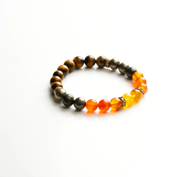 Flat lay of wealth bracelet with tiger eye, pyrite, carnelian and citrine beads on white
