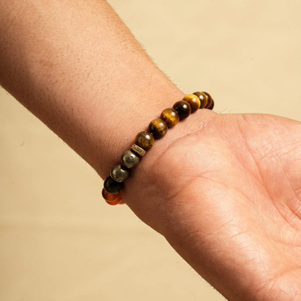 Wealth bracelet on wrist showing tiger eye and pyrite beads with a crystal spacer